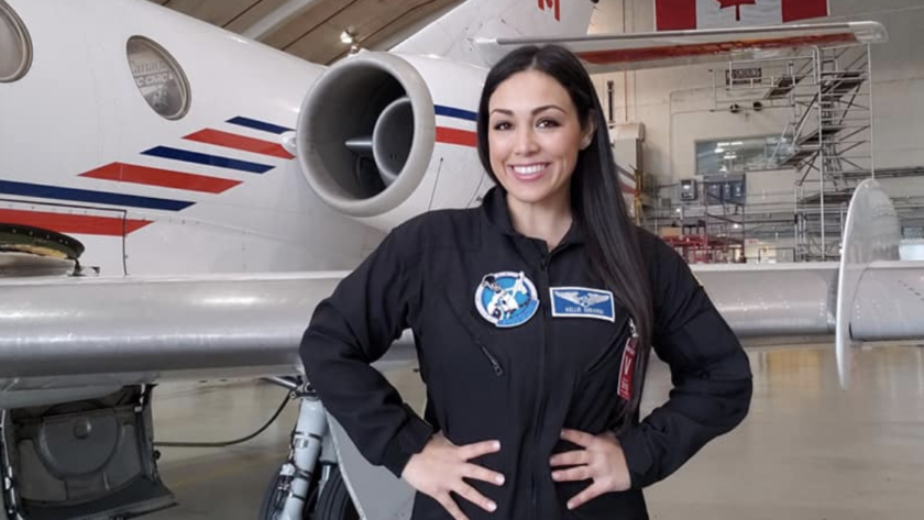 Astronaut Kellie Gerardi posing in front of air craft