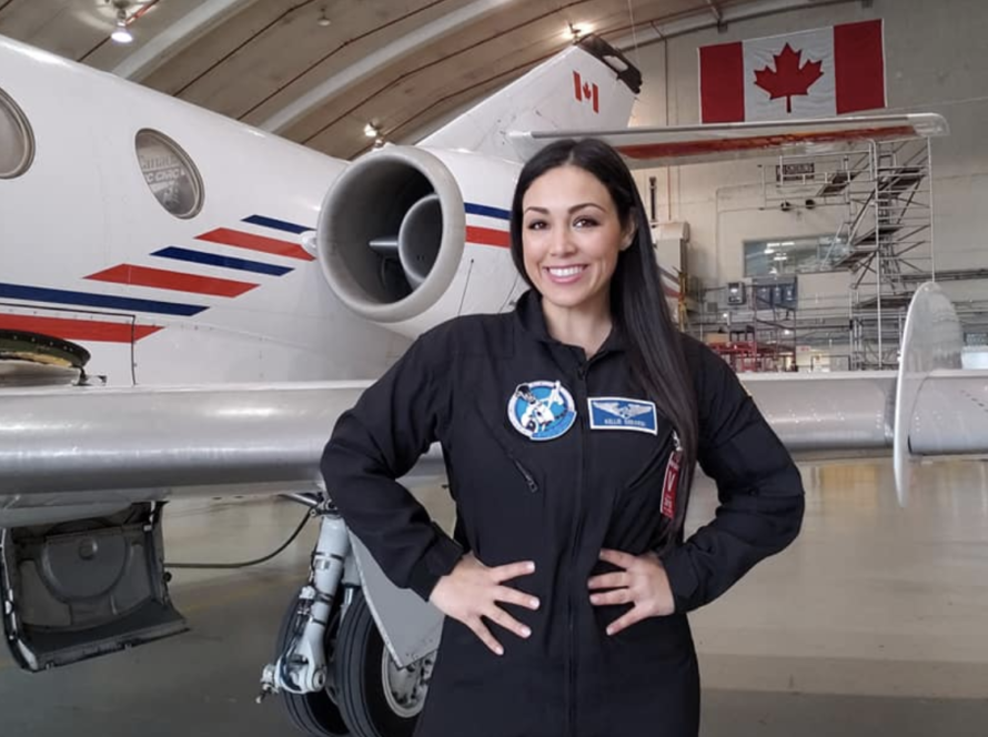 Astronaut Kellie Gerardi posing in front of air craft